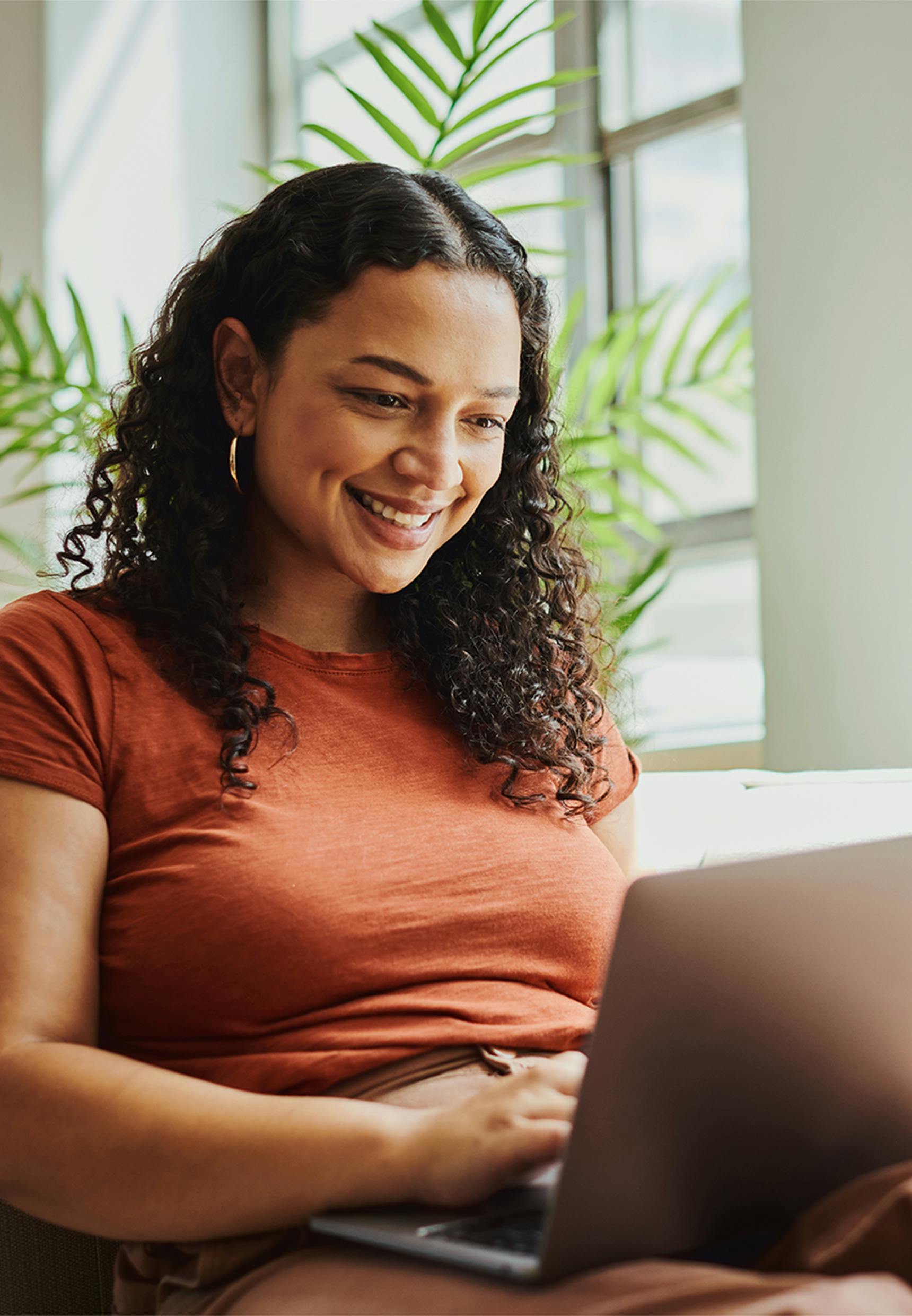 woman smiling at her laptop