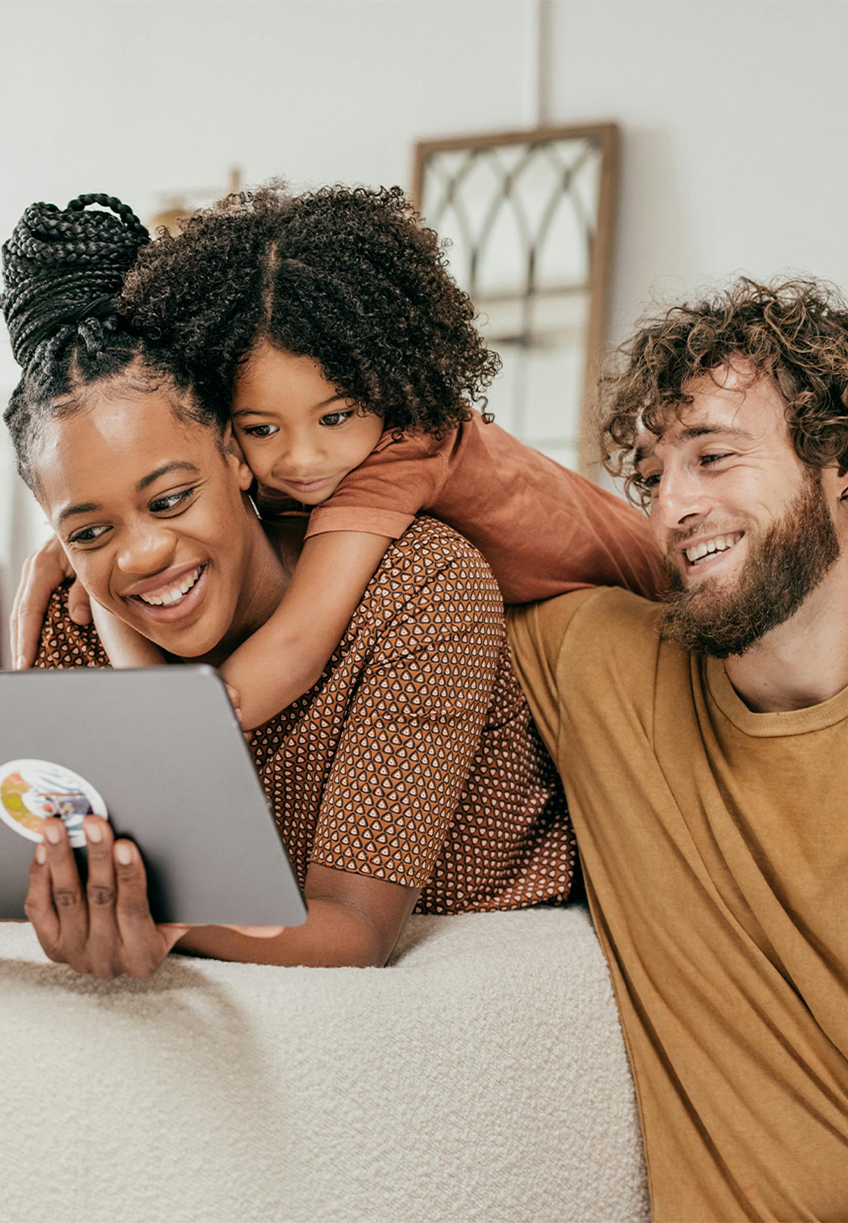 family of three looking at a tablet