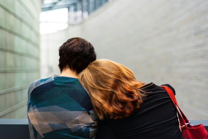 two people leaning into eachother
