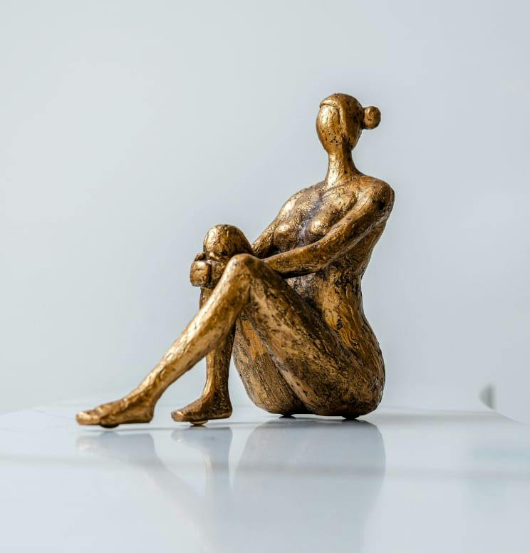 sculpture of a woman's body sitting down