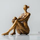 sculpture of a woman's body sitting down