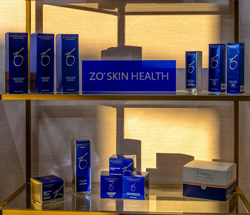 ZO Skin Health products displayed on illuminated gold shelving unit