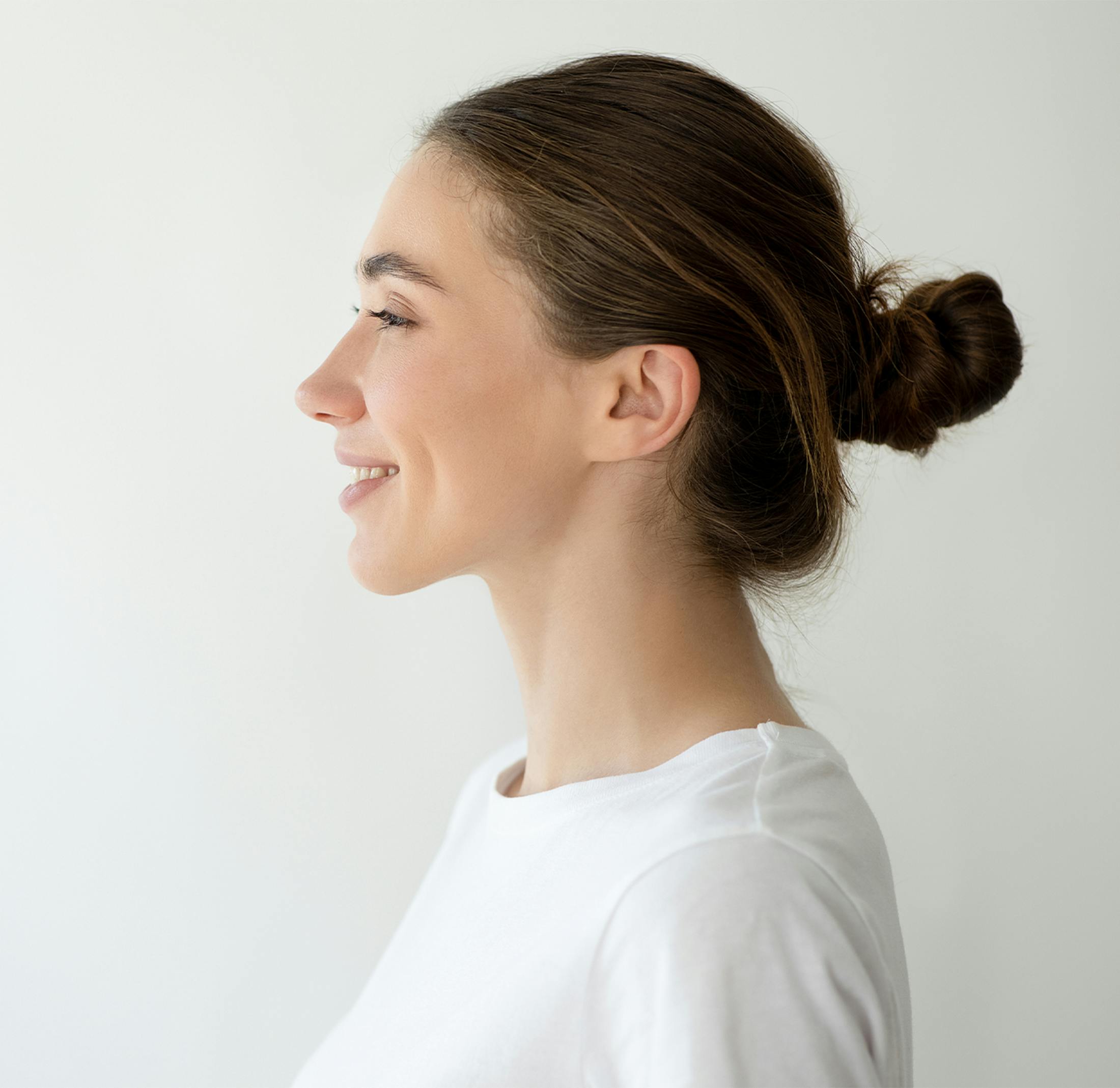 Side profile of a young woman showing her ear area