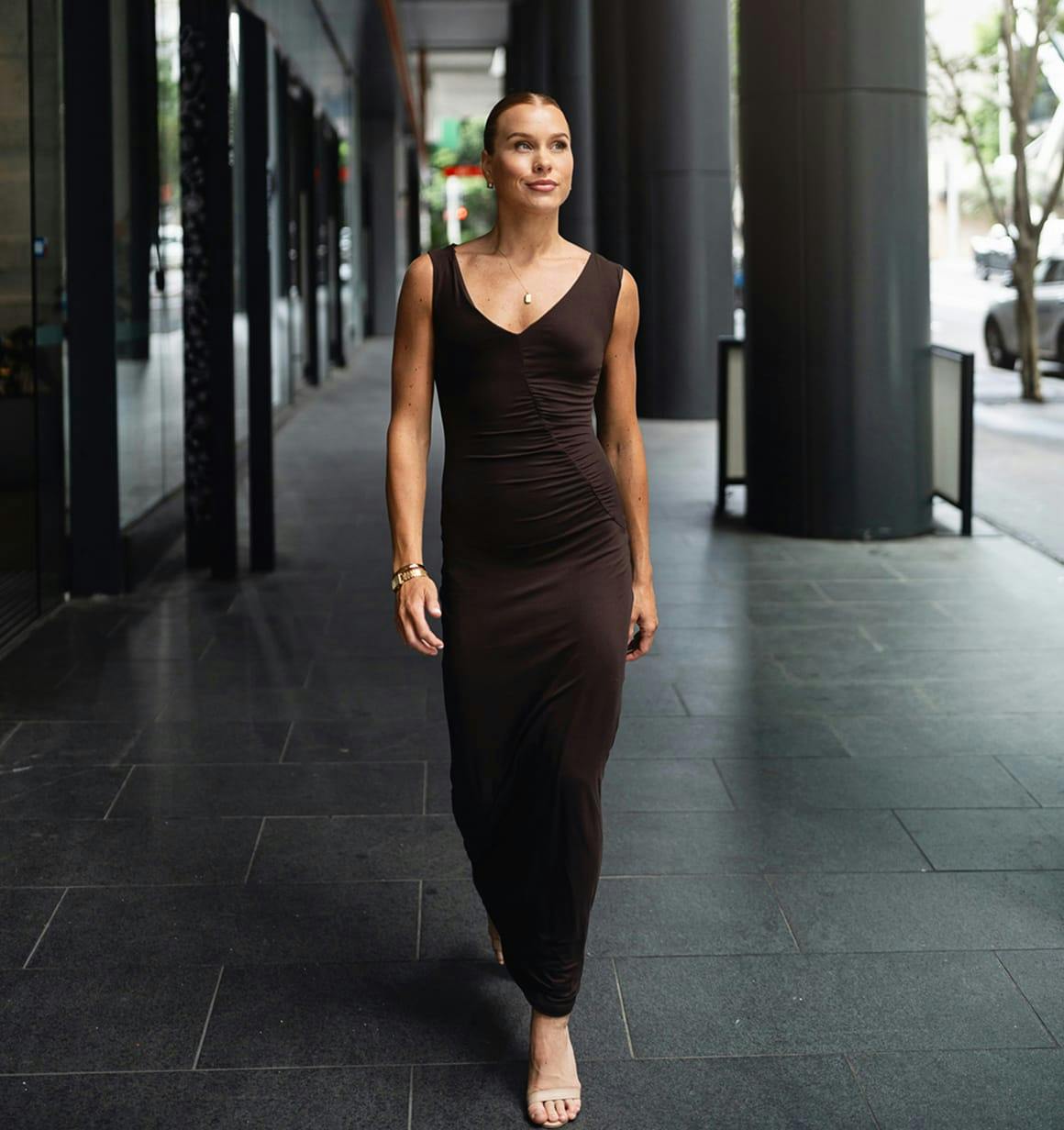 woman walking in brown dress