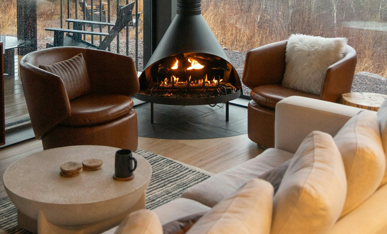 An indoor fireplace surrounded by furniture.