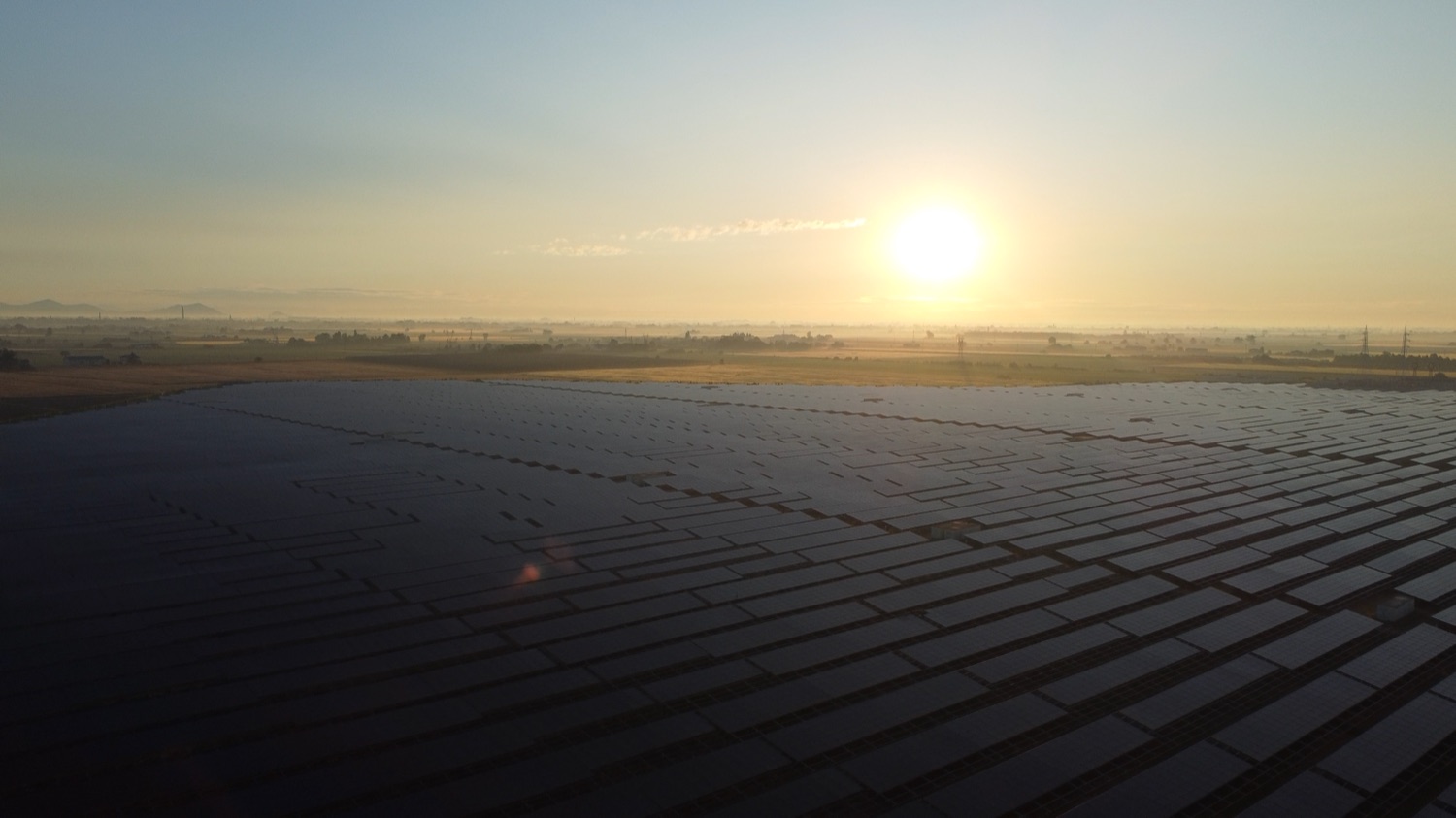 An aerial view of a large ground-mounted solar plant