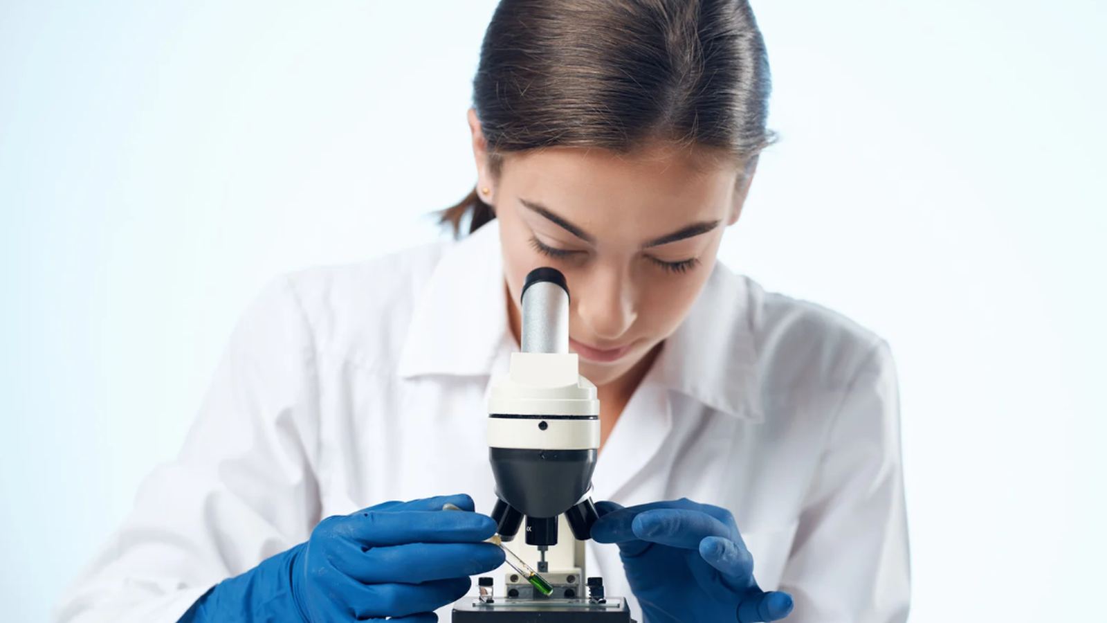 Two lab technicians examining a sample in a pharmaceutical laboratory