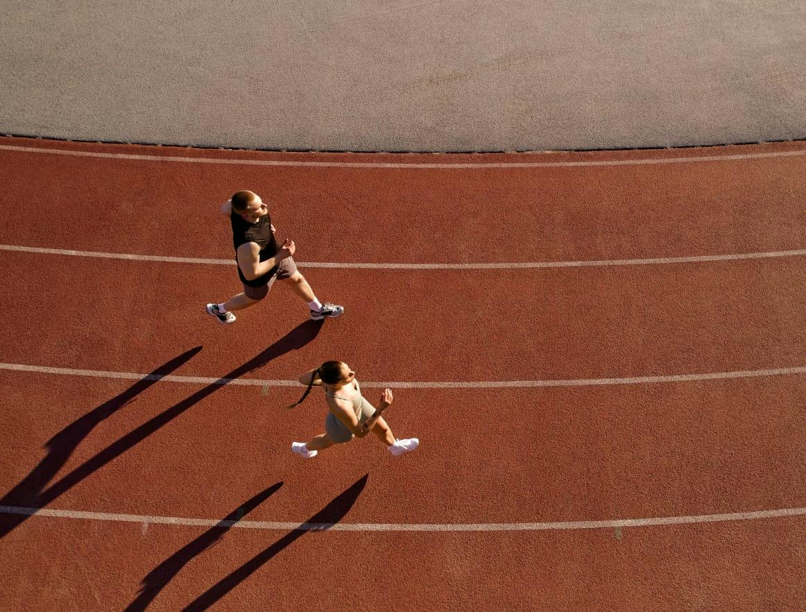 Two people running on a track
