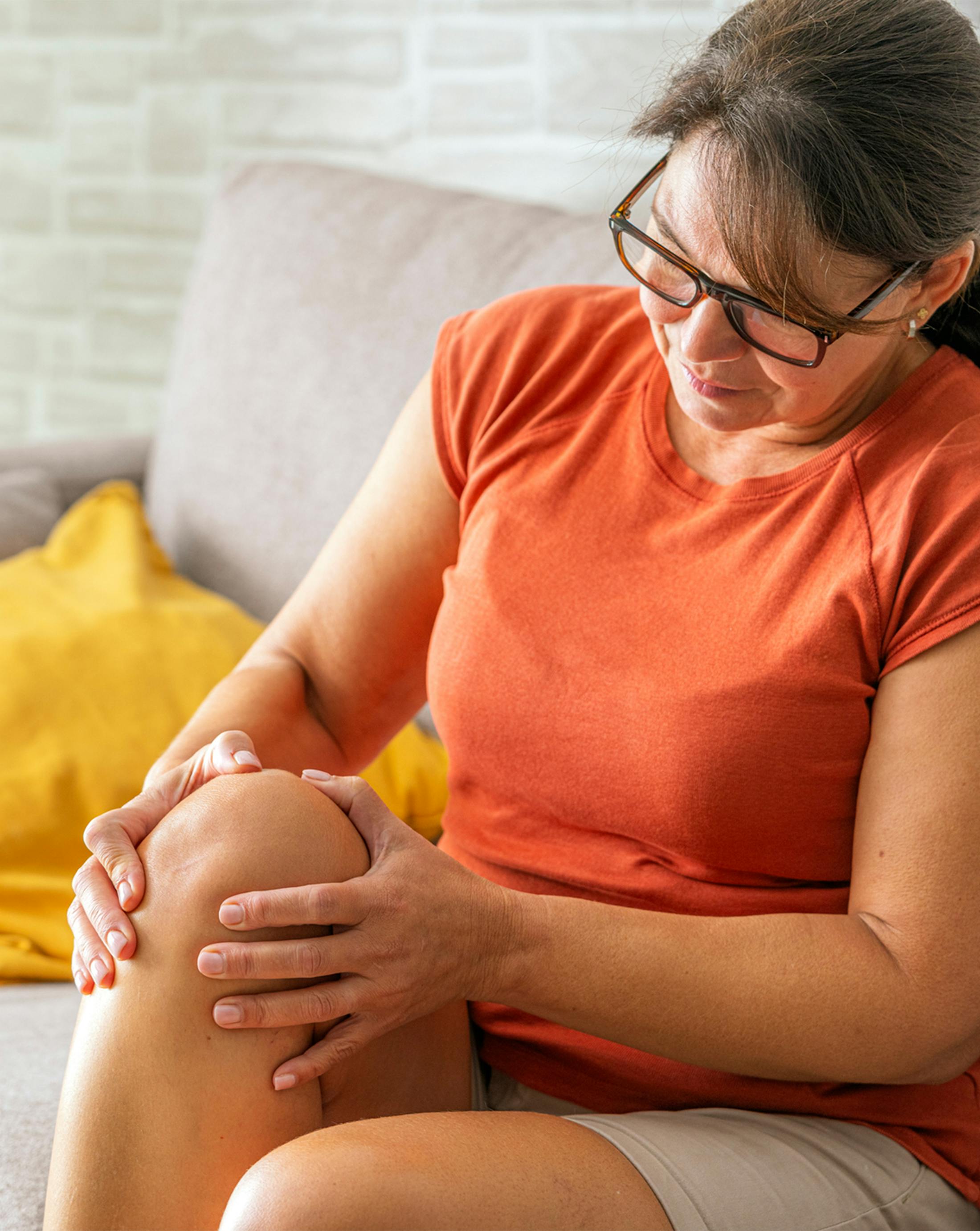 A woman holding her knee