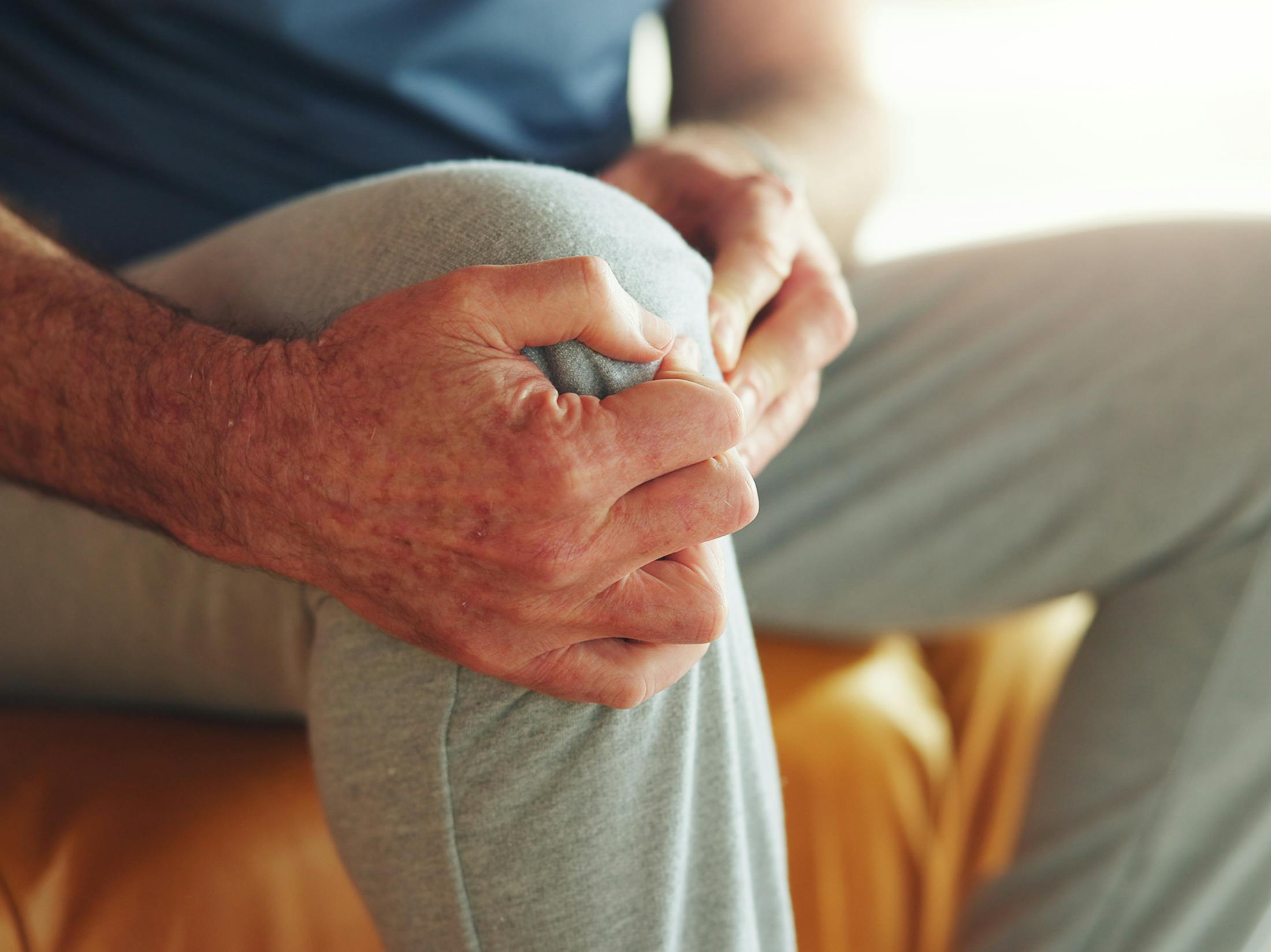 A person holding their knee