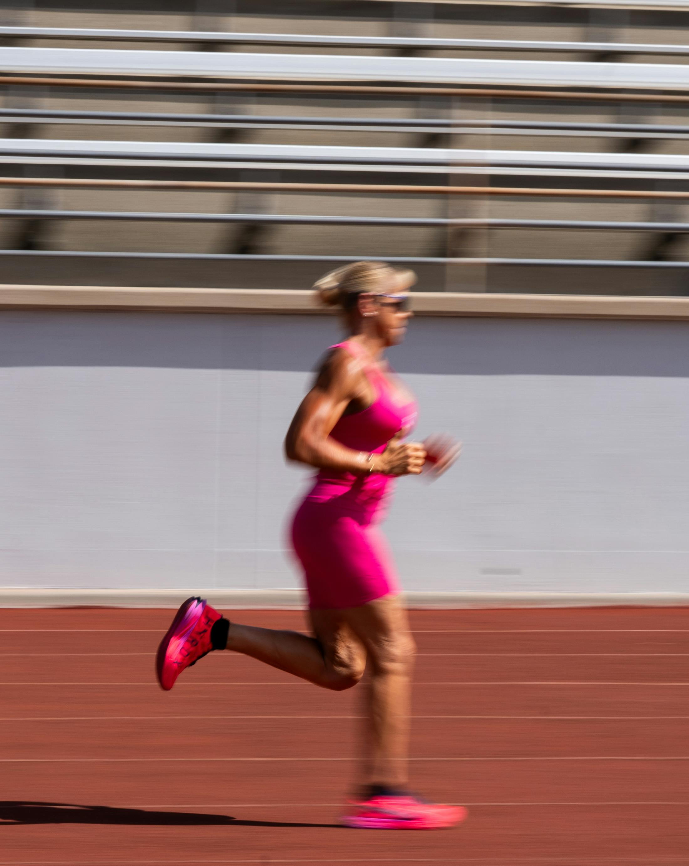 blurry photo of lady in pink running