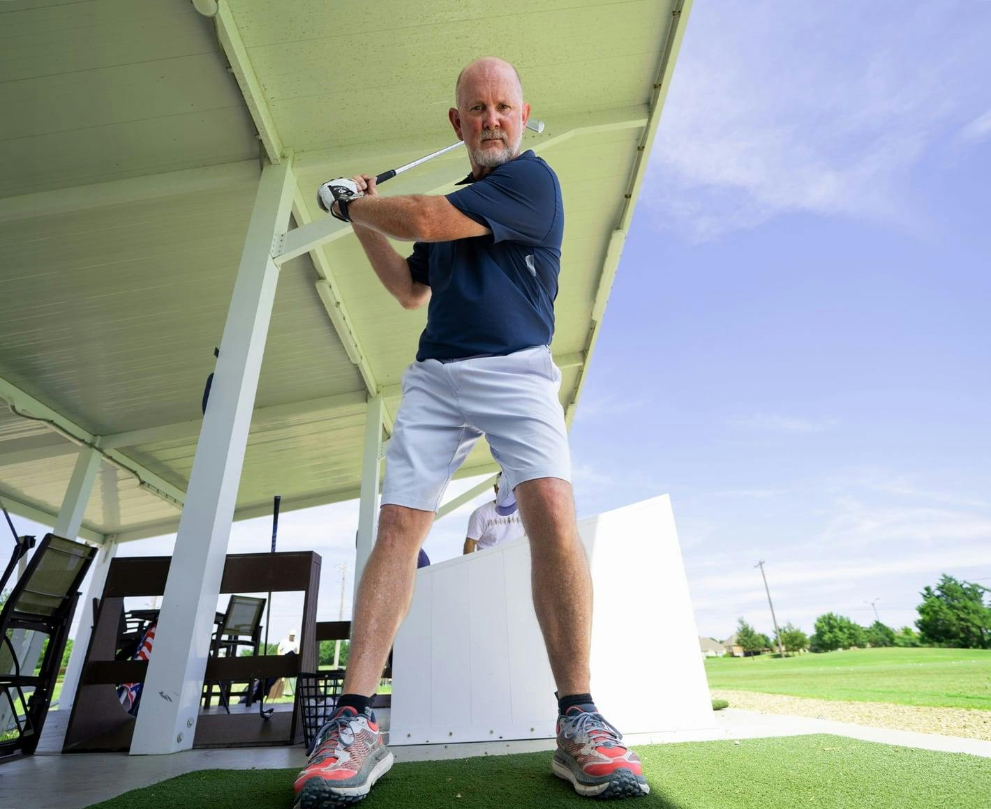 man swinging golf club