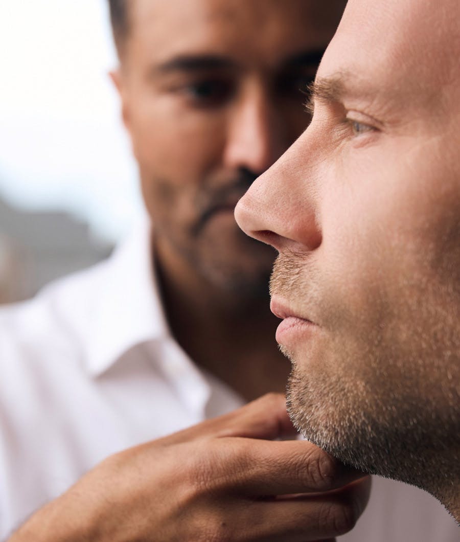 doctor holding man's face