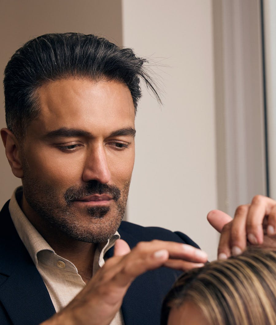 Doctor looking at a patients hair