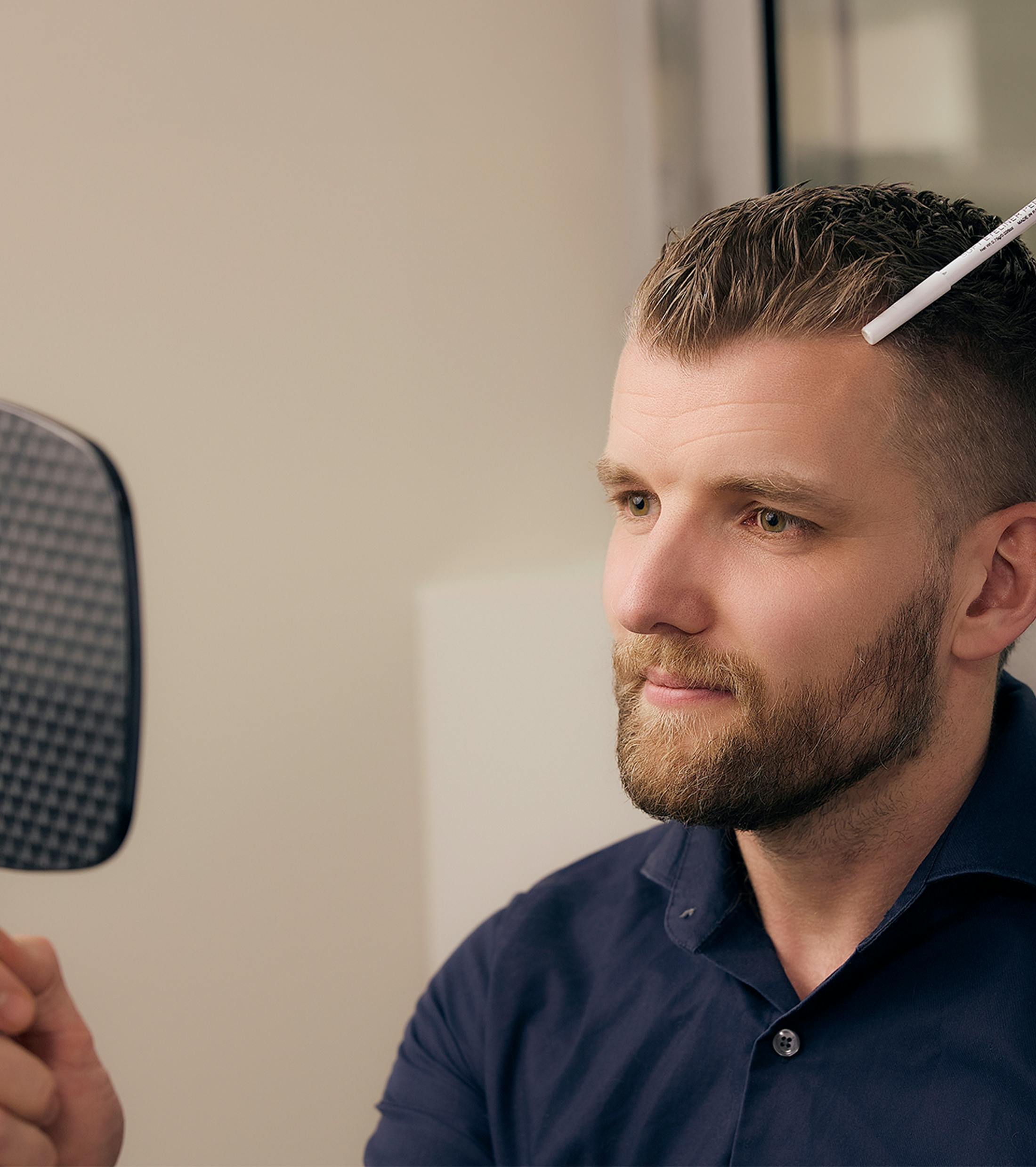 patient looking at his results in a hand mirror