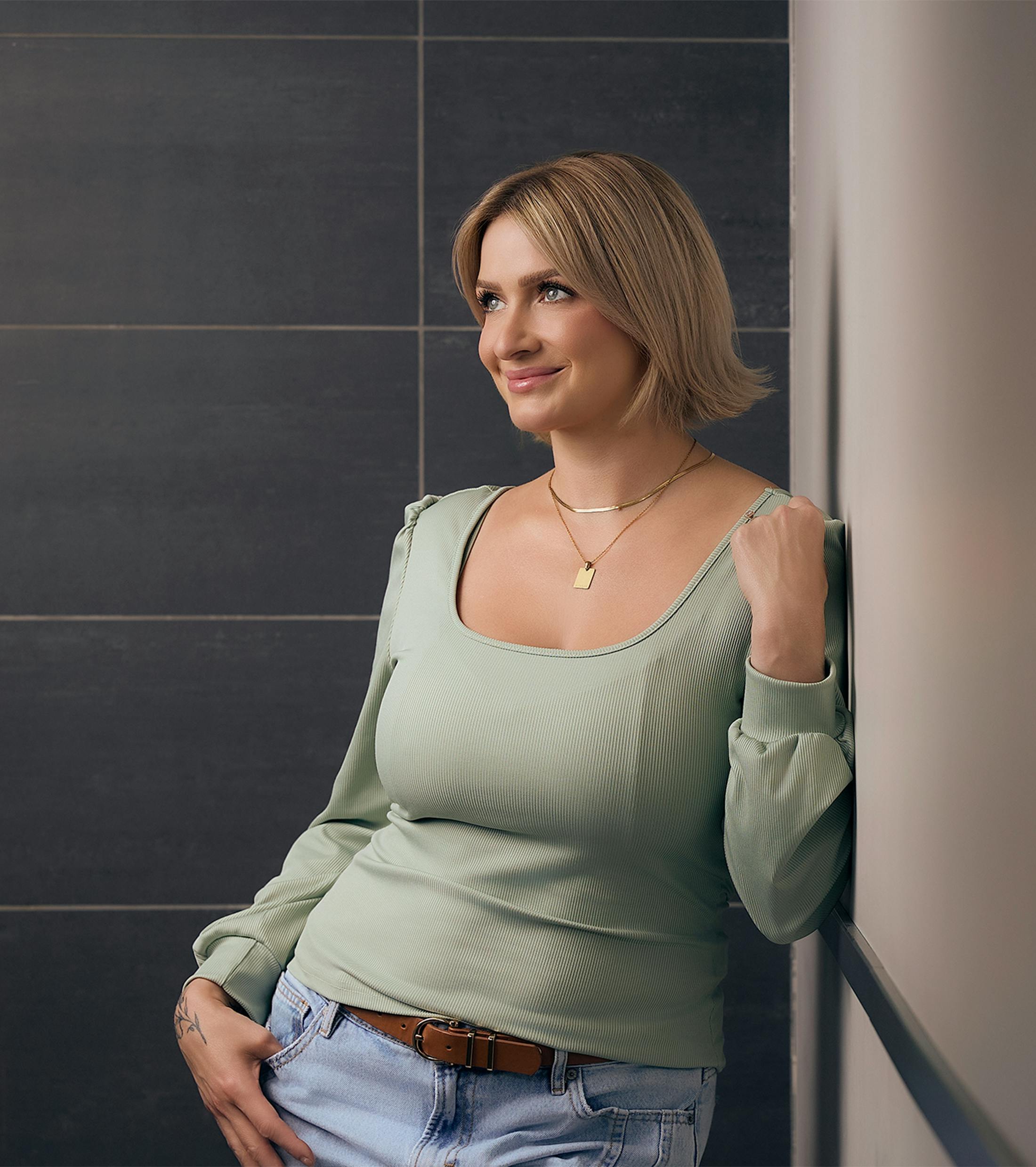 woman leaning against a wall