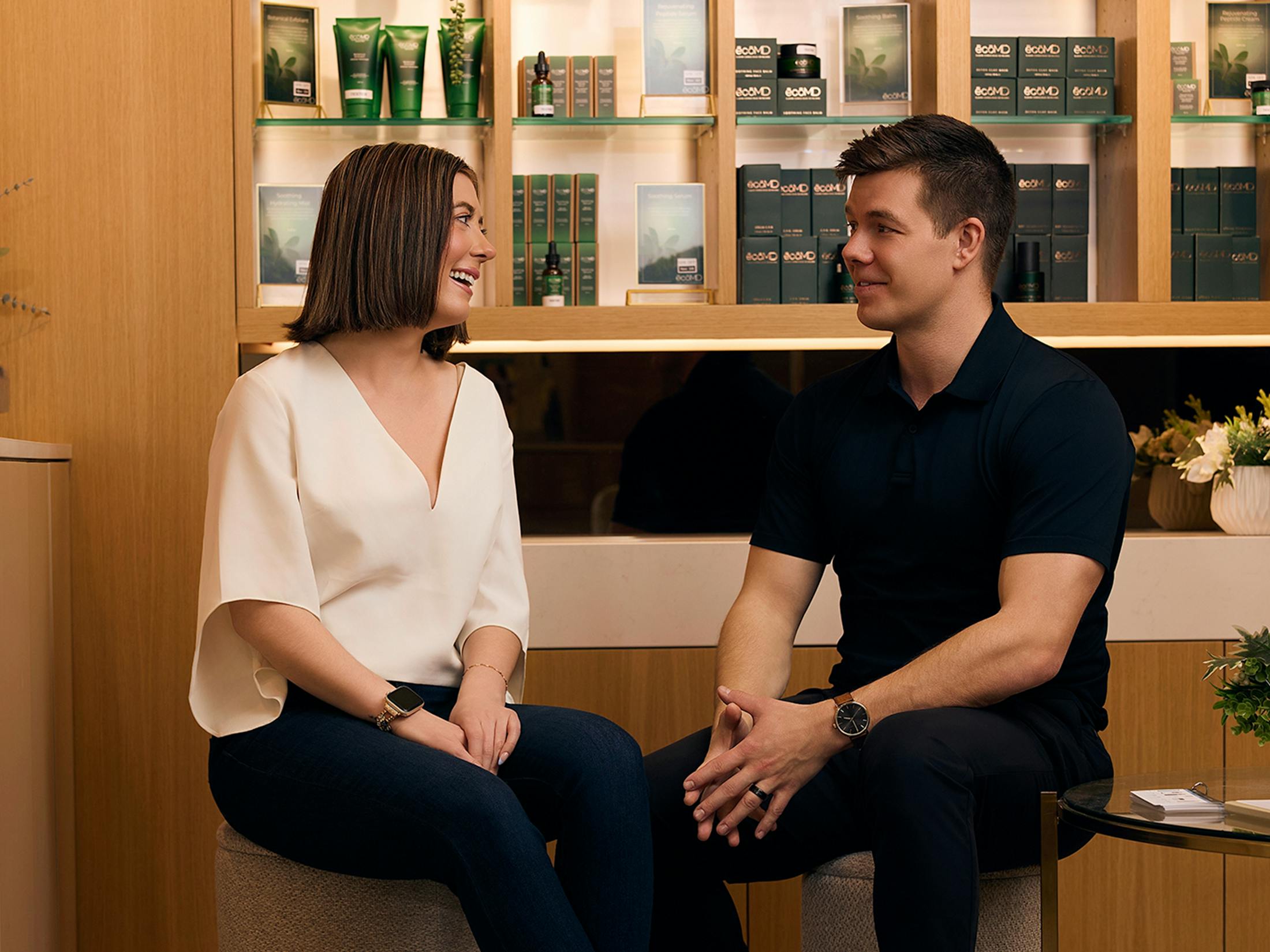 two people sitting on stools
