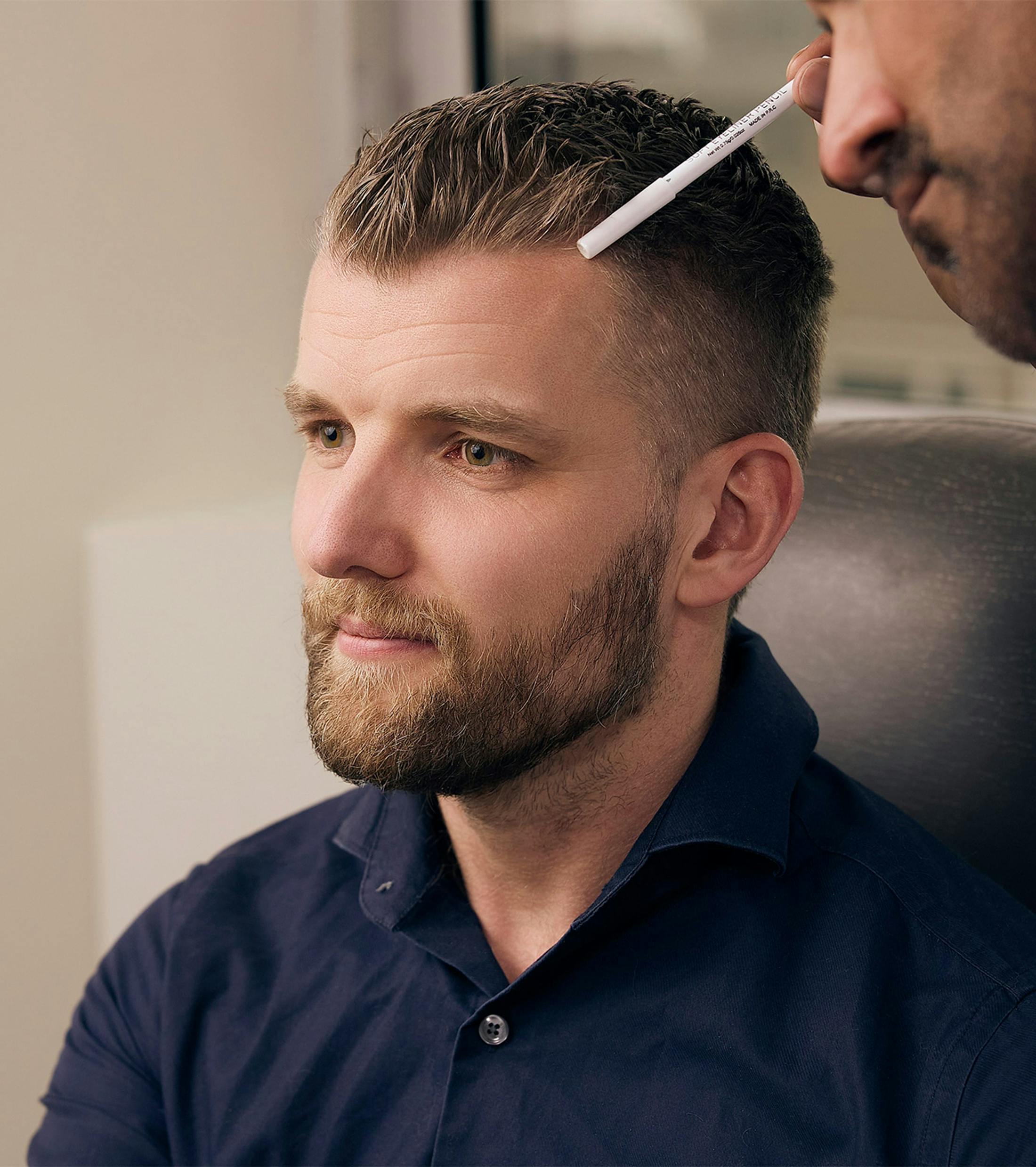 doctor looking at a patient's hairline