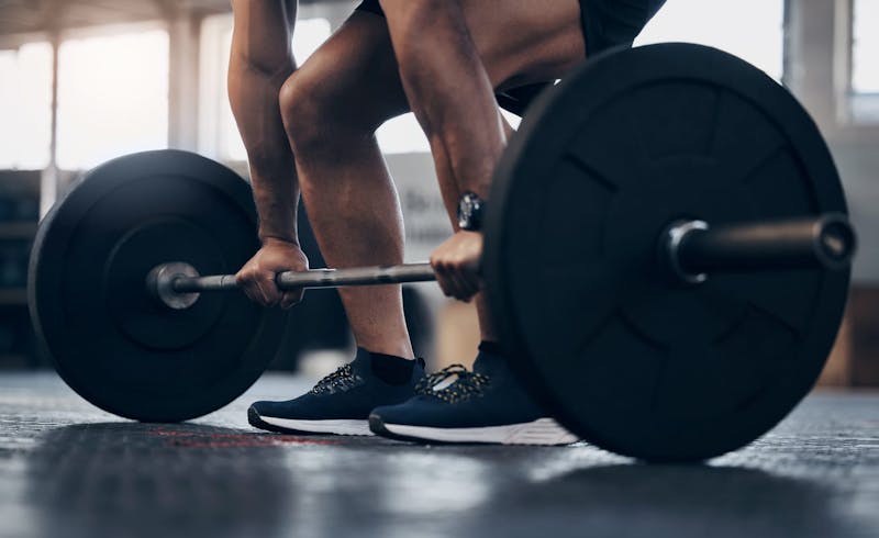 man lifting weights
