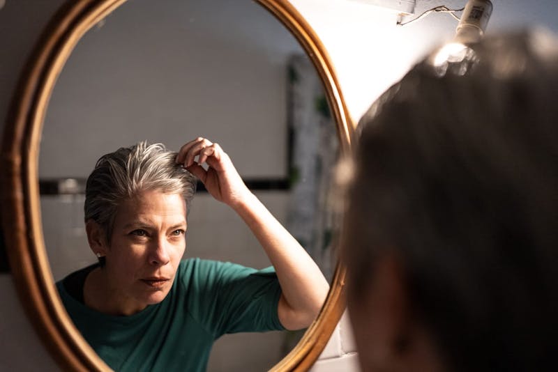 woman looking in the mirror