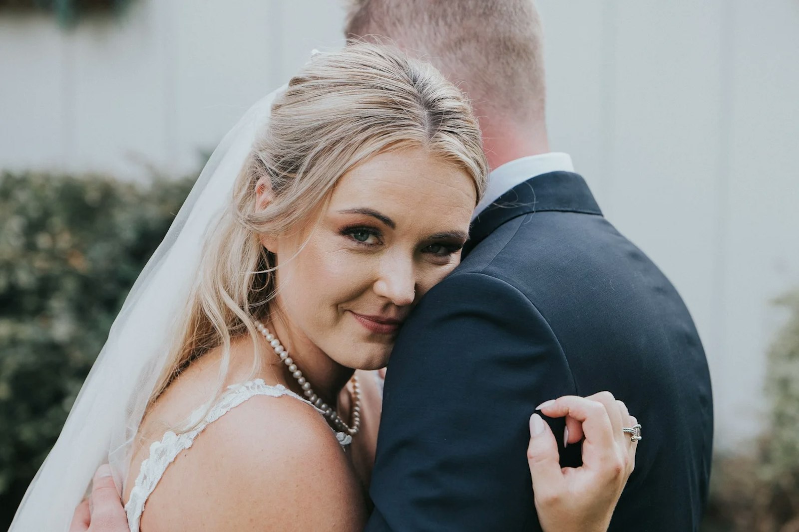 Bride resting her head on her groom's shoulder