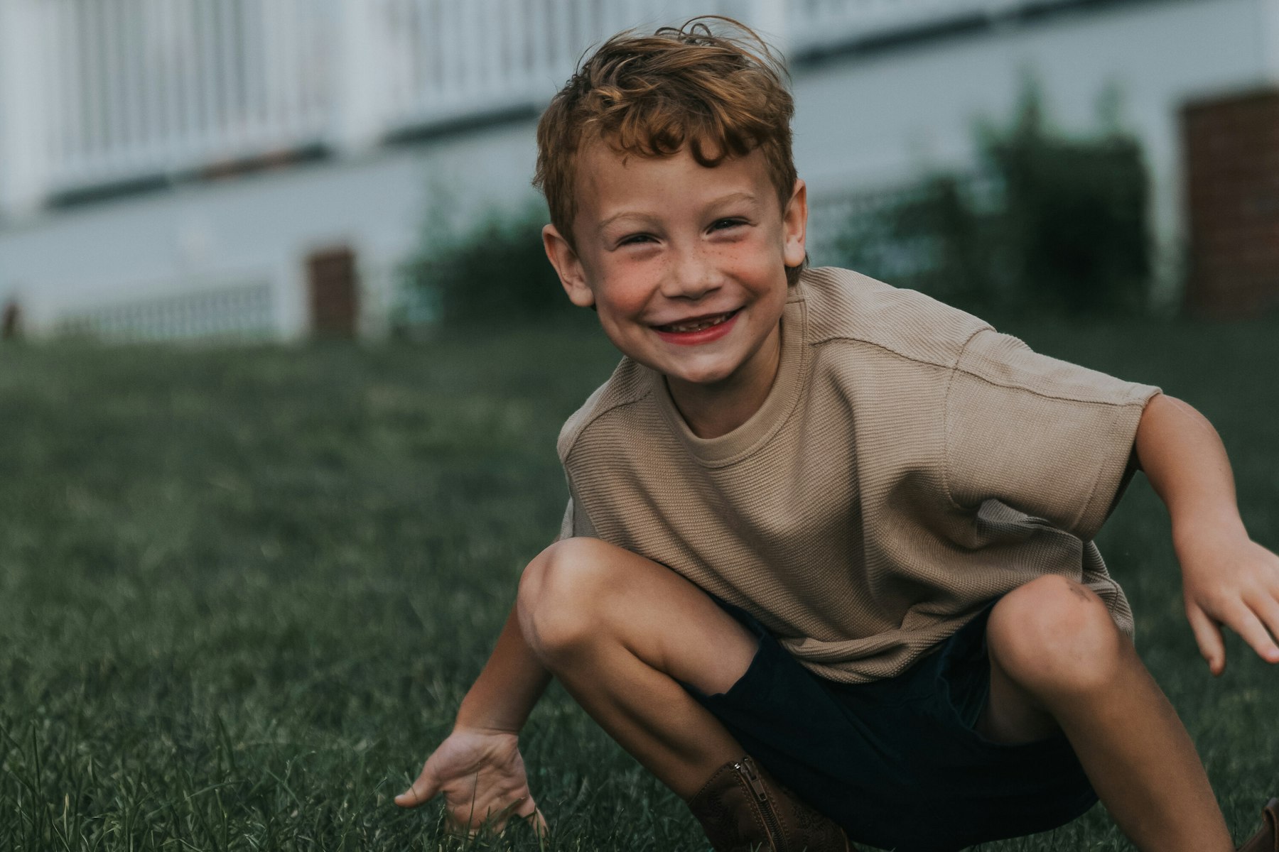 Little boy grinning as he crawls through the grass at Veterans Memorial Park in Avon Lake, Ohio