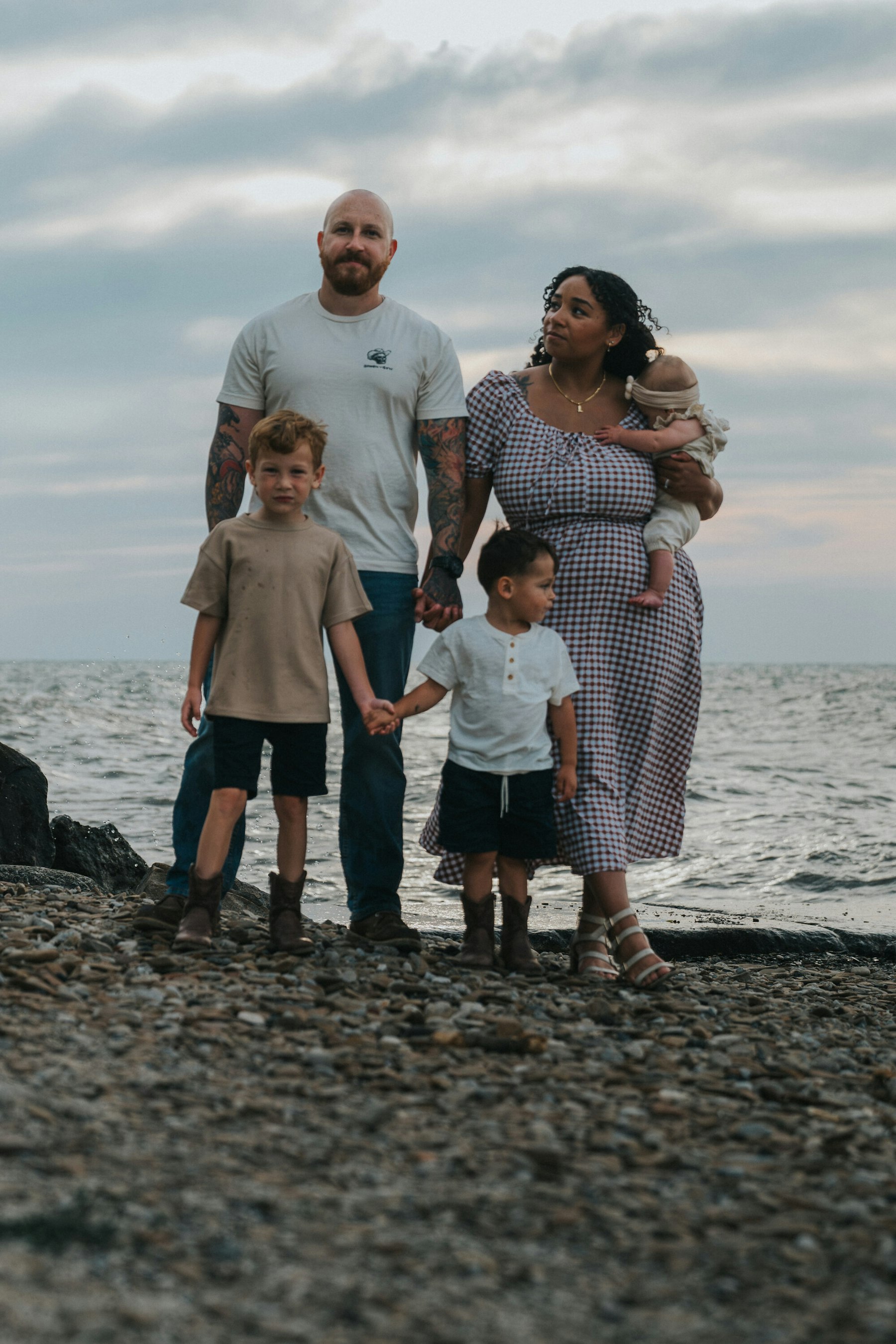 Family standing together on the beach with Lake Erie behind them at Veterans Memorial Park in Avon Lake, Ohio
