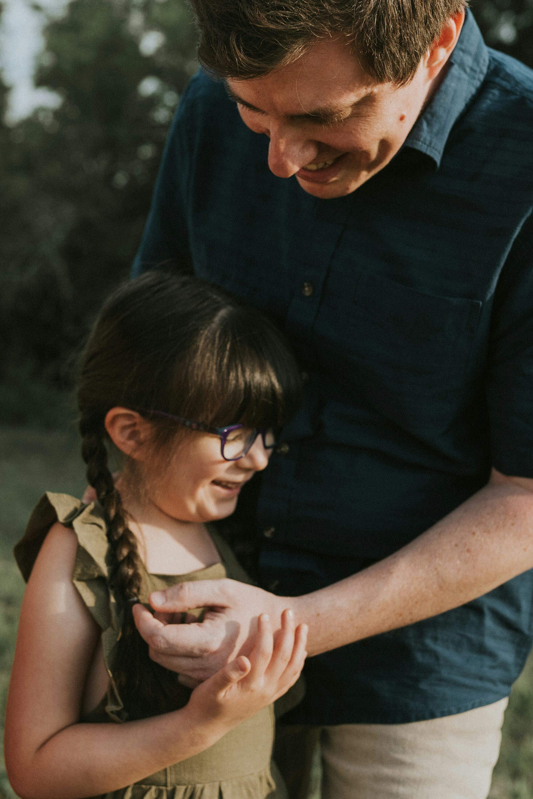 Dad holding his daughter's hands during a family session