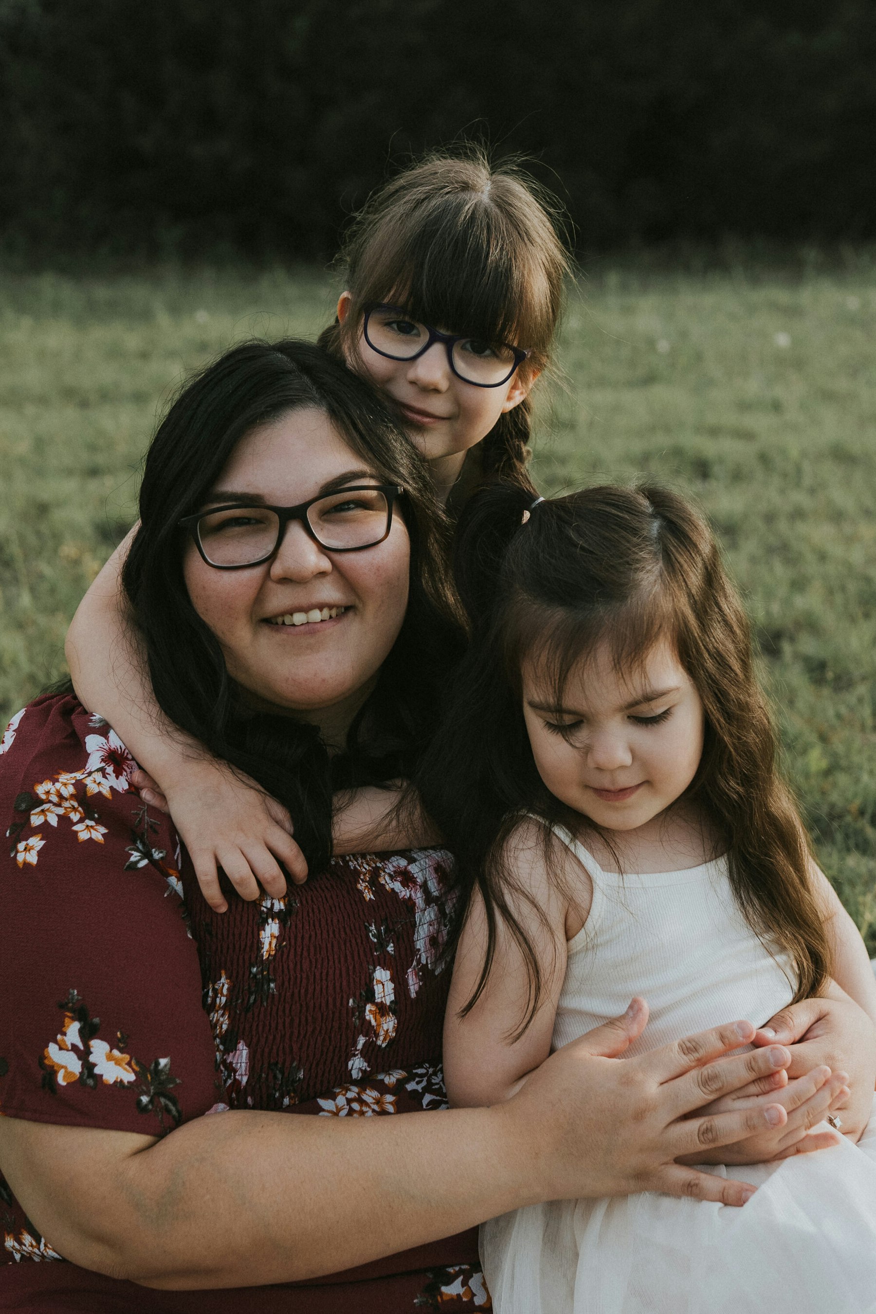 Mom hugging her two daughters during a family session