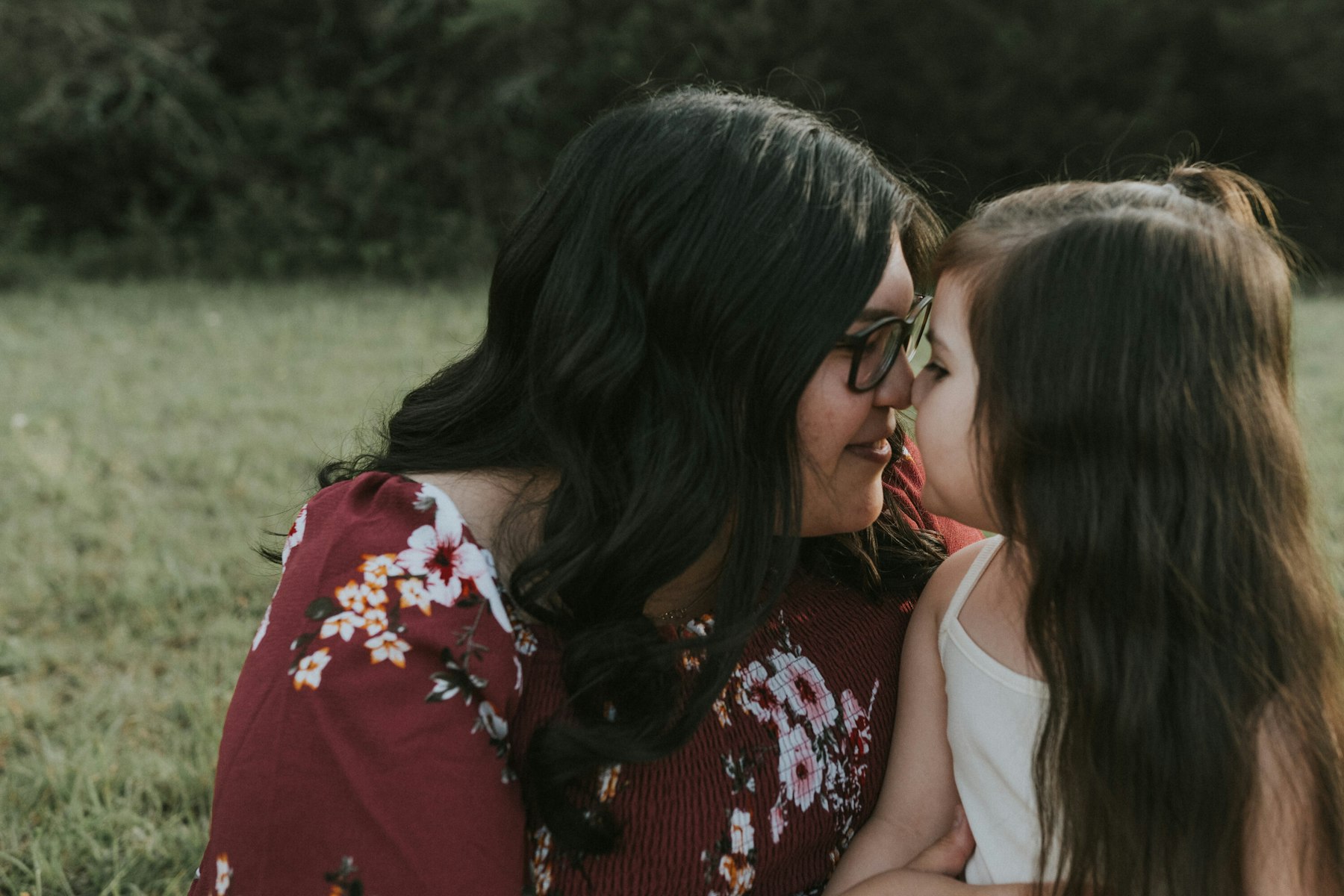 Mom and daughter nose to nose during a family session