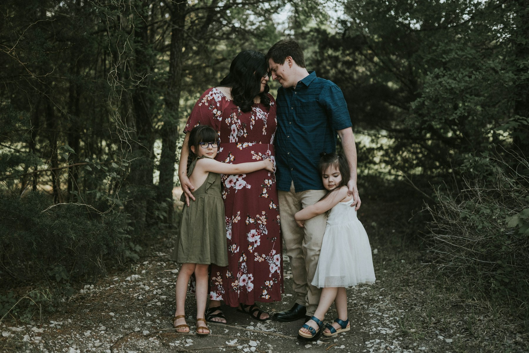 Family of four together among the trees during a family session
