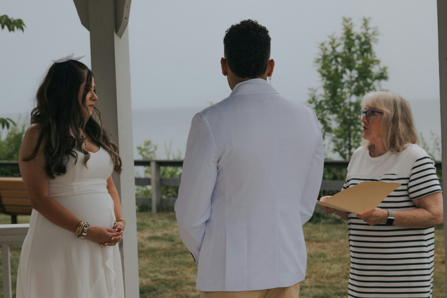 Bride, groom, and officiant under the lakeside gazebo at a Veterans Memorial Park wedding in Avon Lake, Ohio
