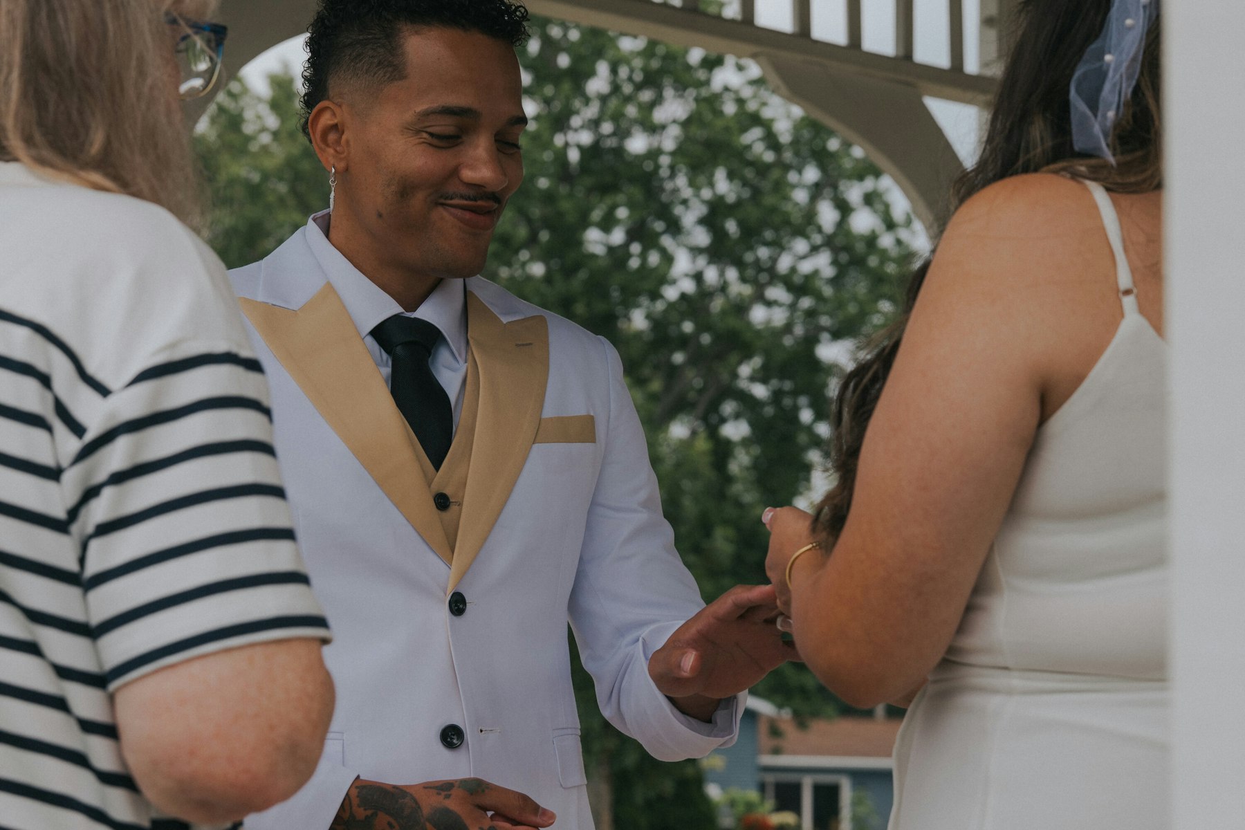 Groom smiling at the bride during their vows at a Veterans Memorial Park wedding in Avon Lake, Ohio