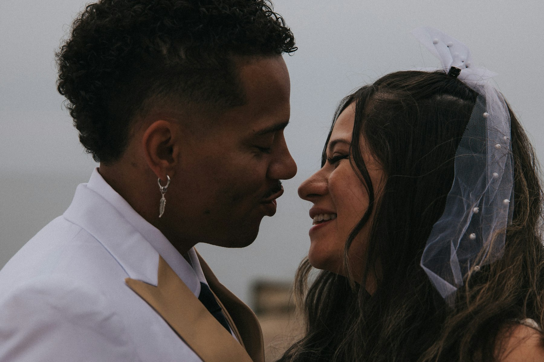 Bride and groom nose to nose, veil in the wind at a Veterans Memorial Park wedding in Avon Lake, Ohio
