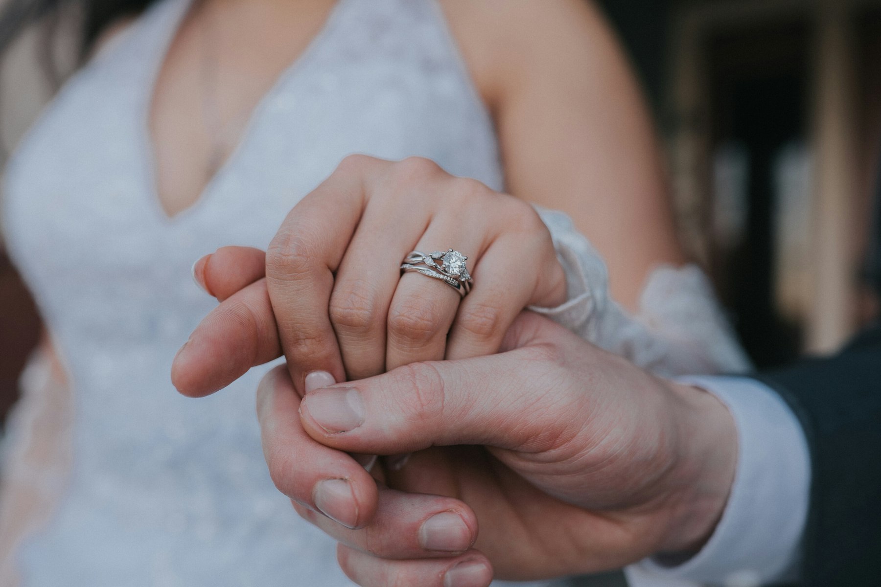 Close up of the couple's hands and rings at a garden wedding
