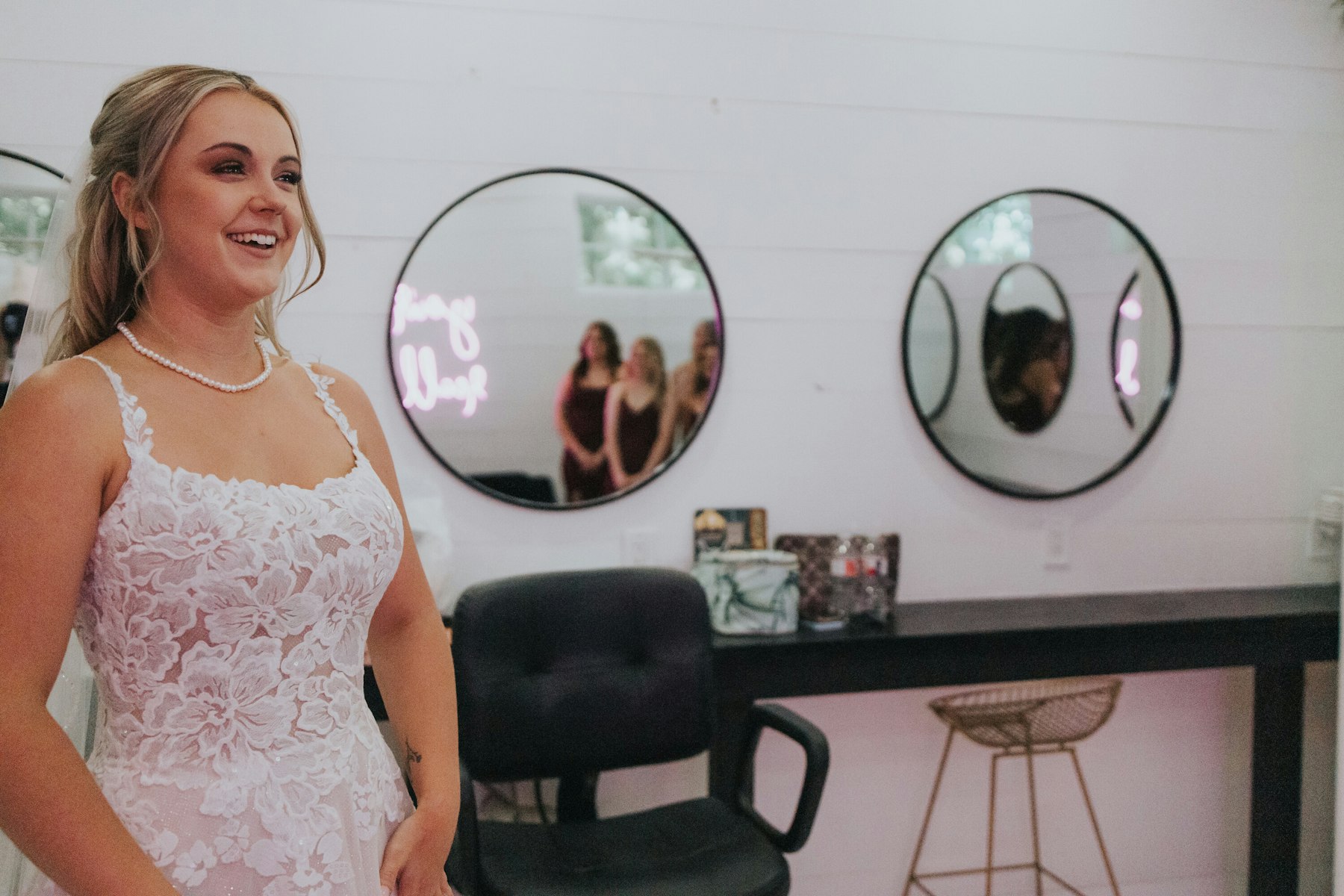 Bride laughing in the getting ready suite at a white barn wedding