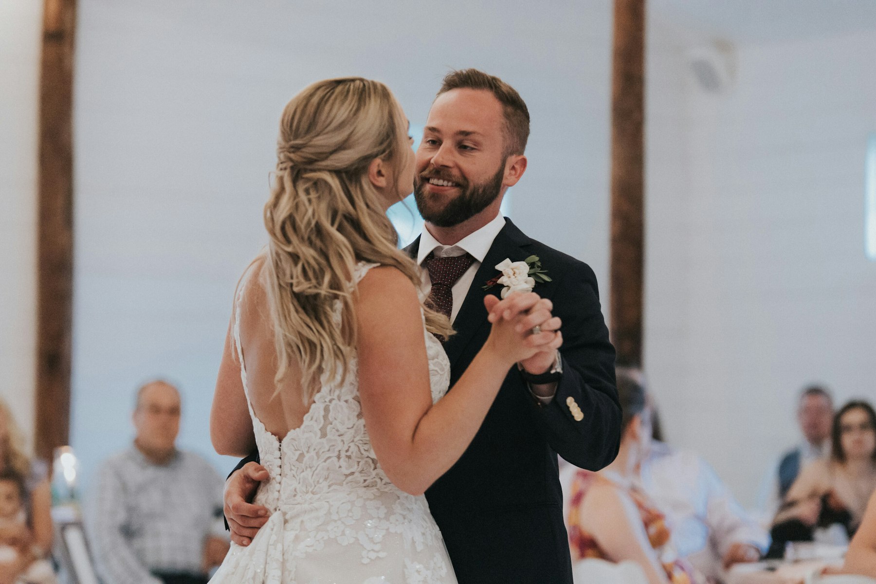 Bride and groom's first dance in the white barn at a white barn wedding