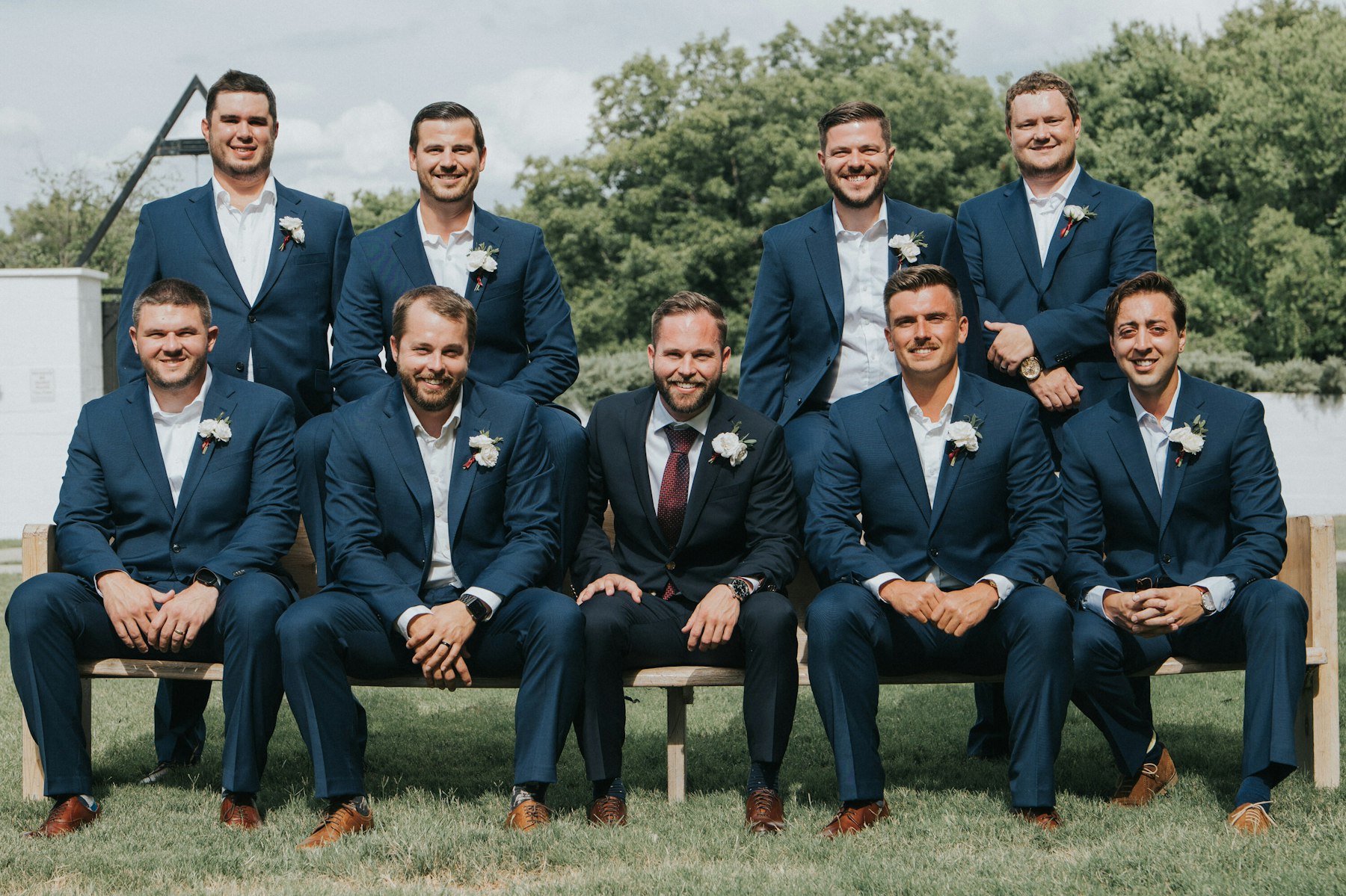 Groomsmen group portrait on the lawn at a white barn wedding