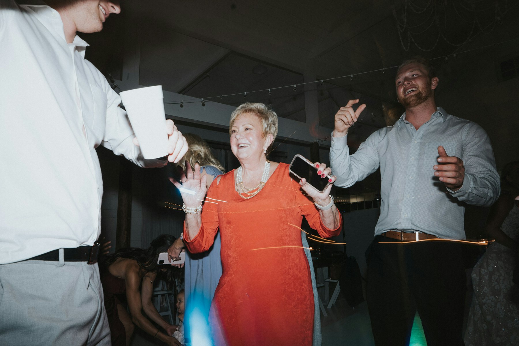 Guests dancing at the reception at a white barn wedding