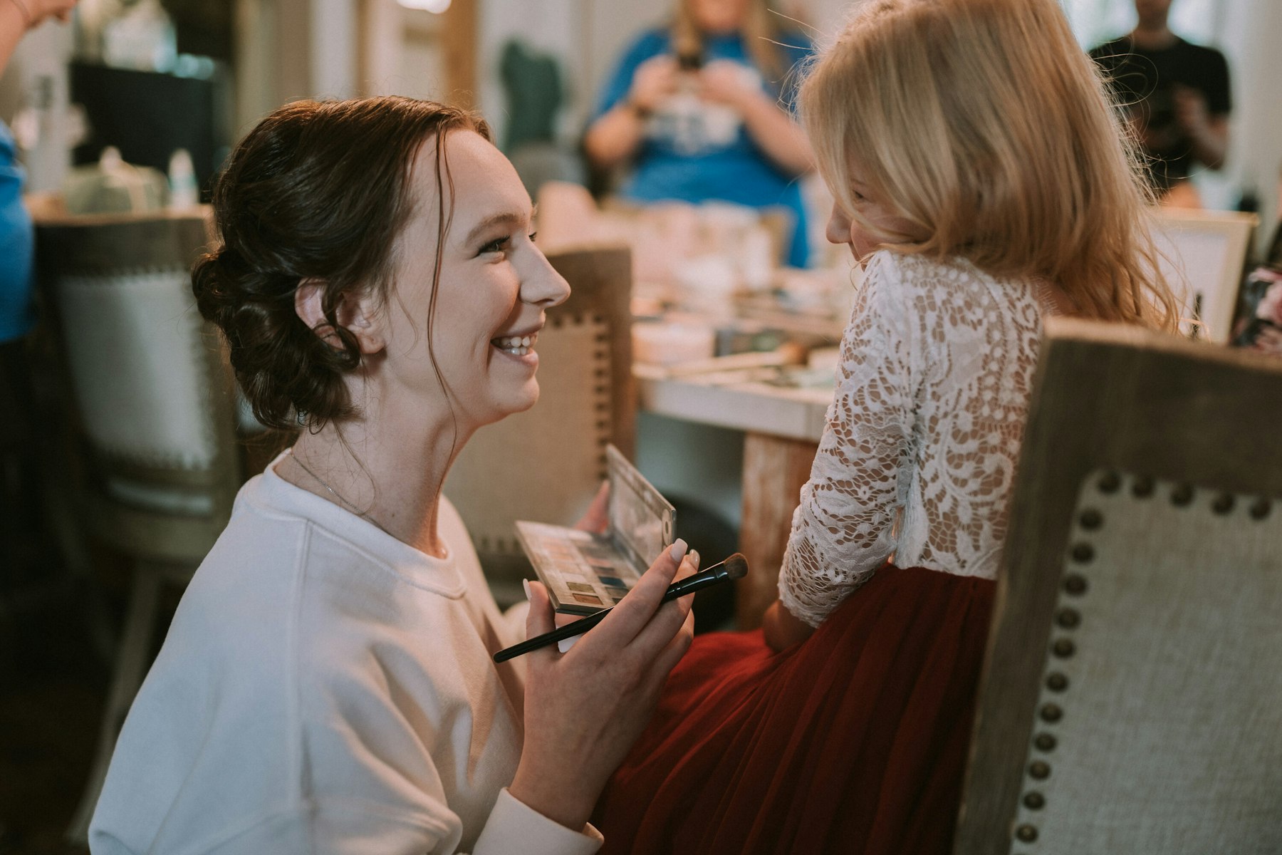 Bride laughing while getting ready at a rustic barn wedding