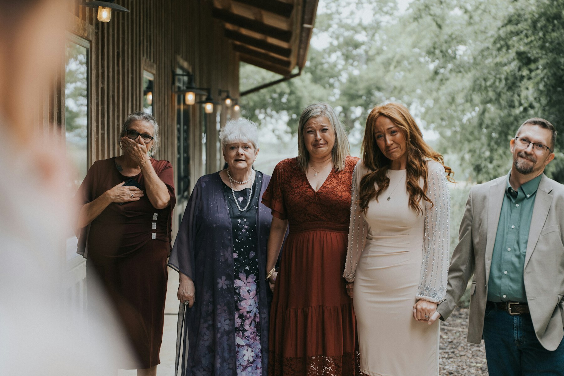 Family reacting during the ceremony at a rustic barn wedding