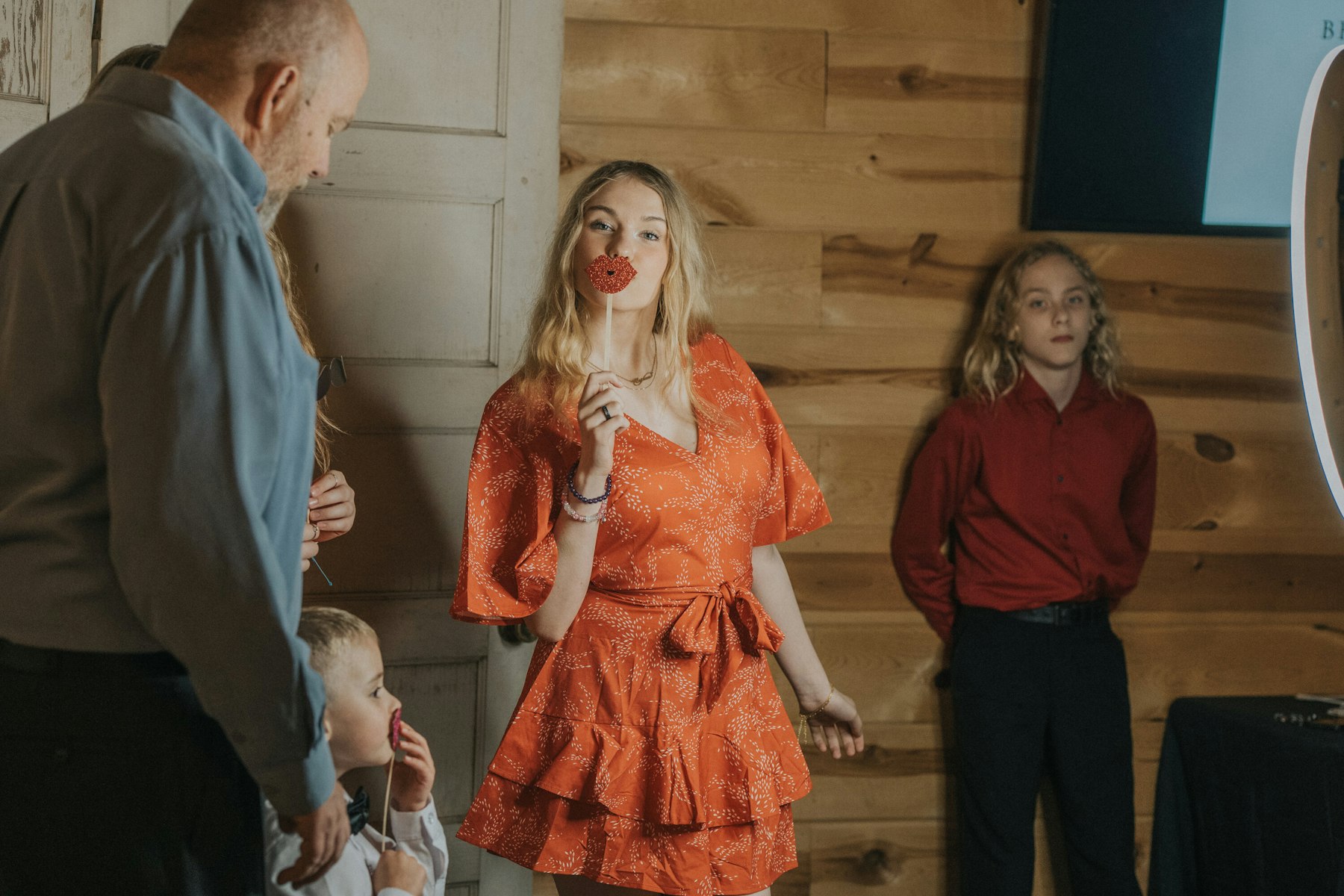 Guests at the photo booth at a rustic barn wedding