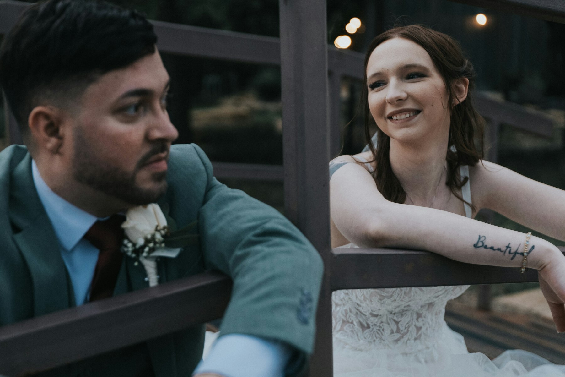 Bride and groom at the reception window at a rustic barn wedding