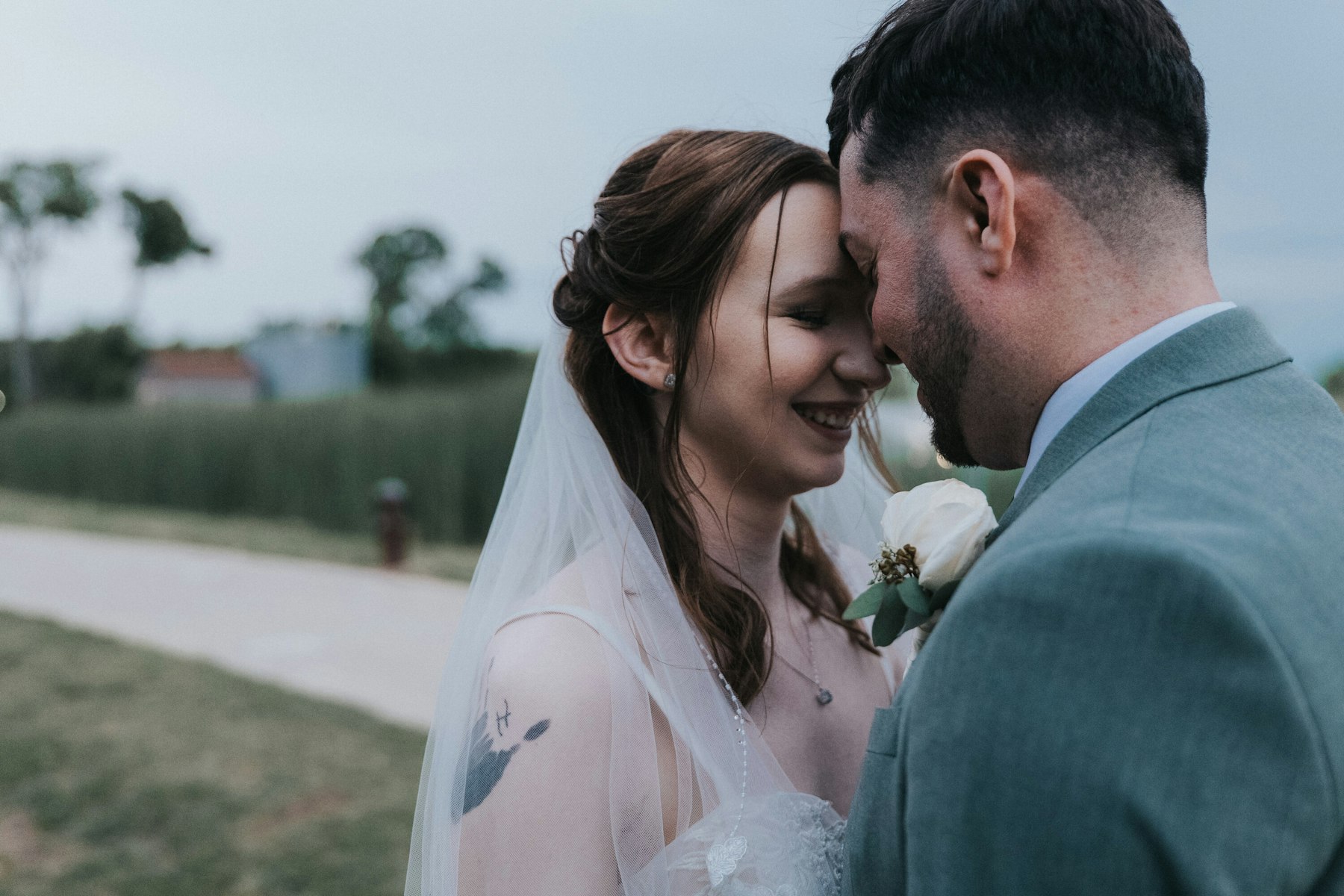 Bride and groom forehead to forehead at a rustic barn wedding