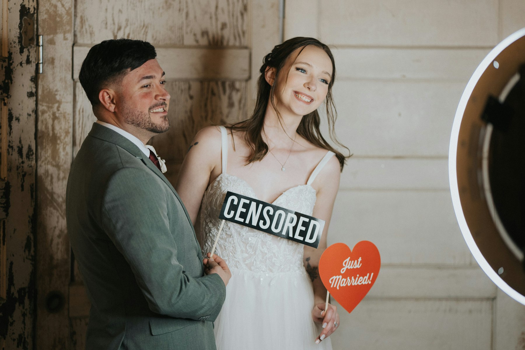 Photo booth "censored" sign and just married heart at a rustic barn wedding