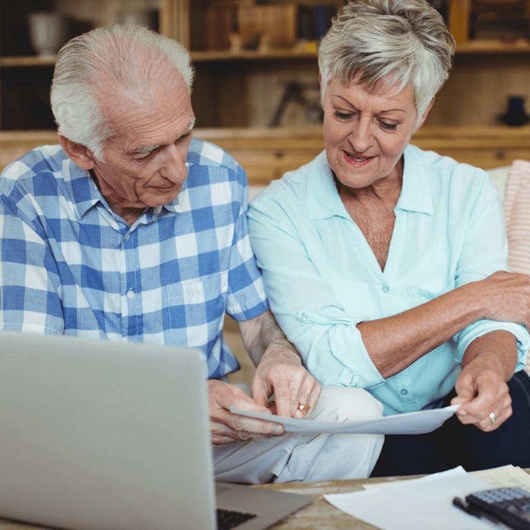 Older couple looking through bills together