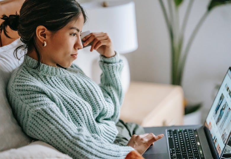 Woman browsing the Internet on her laptop
