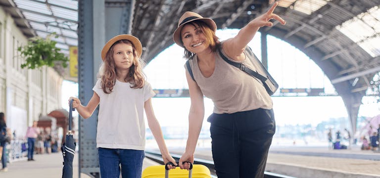 Woman and child going on a trip via train