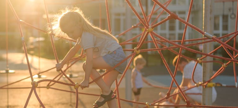Children playing in playground at sunset