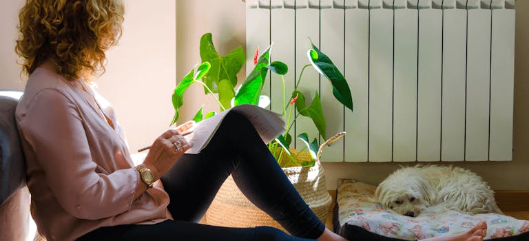Woman sitting on floor doing bills